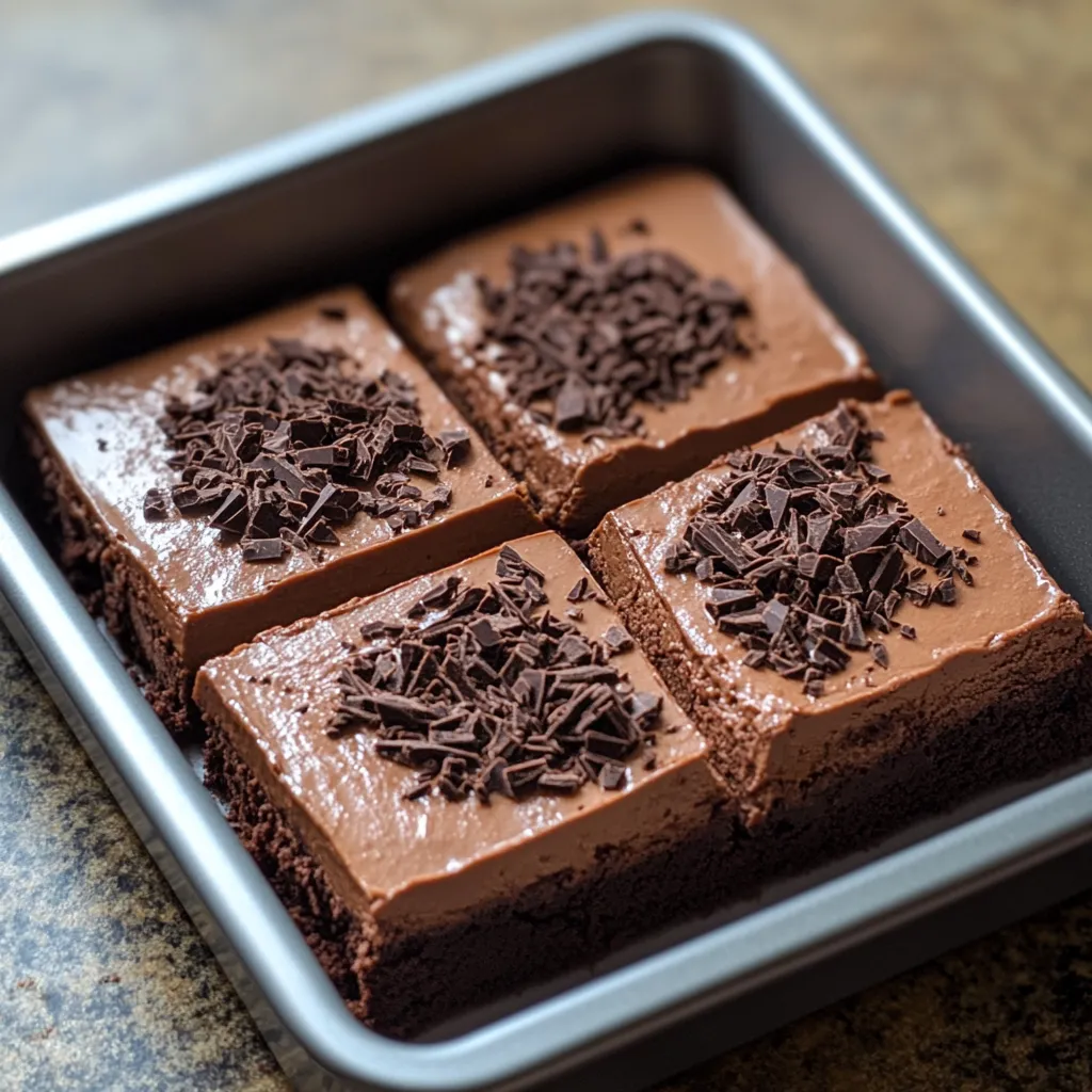 A square of chocolate cake with chocolate chips.