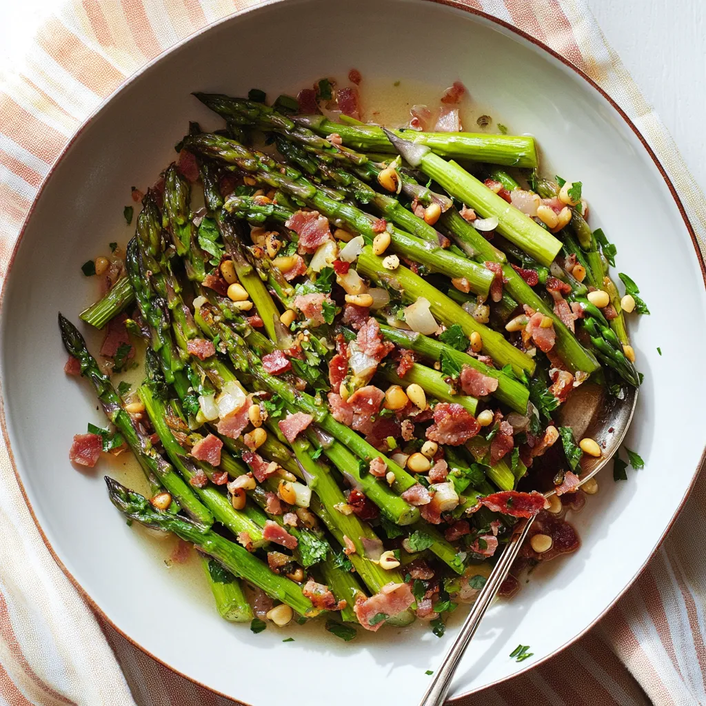 A plate loaded with asparagus and crispy bacon bits.