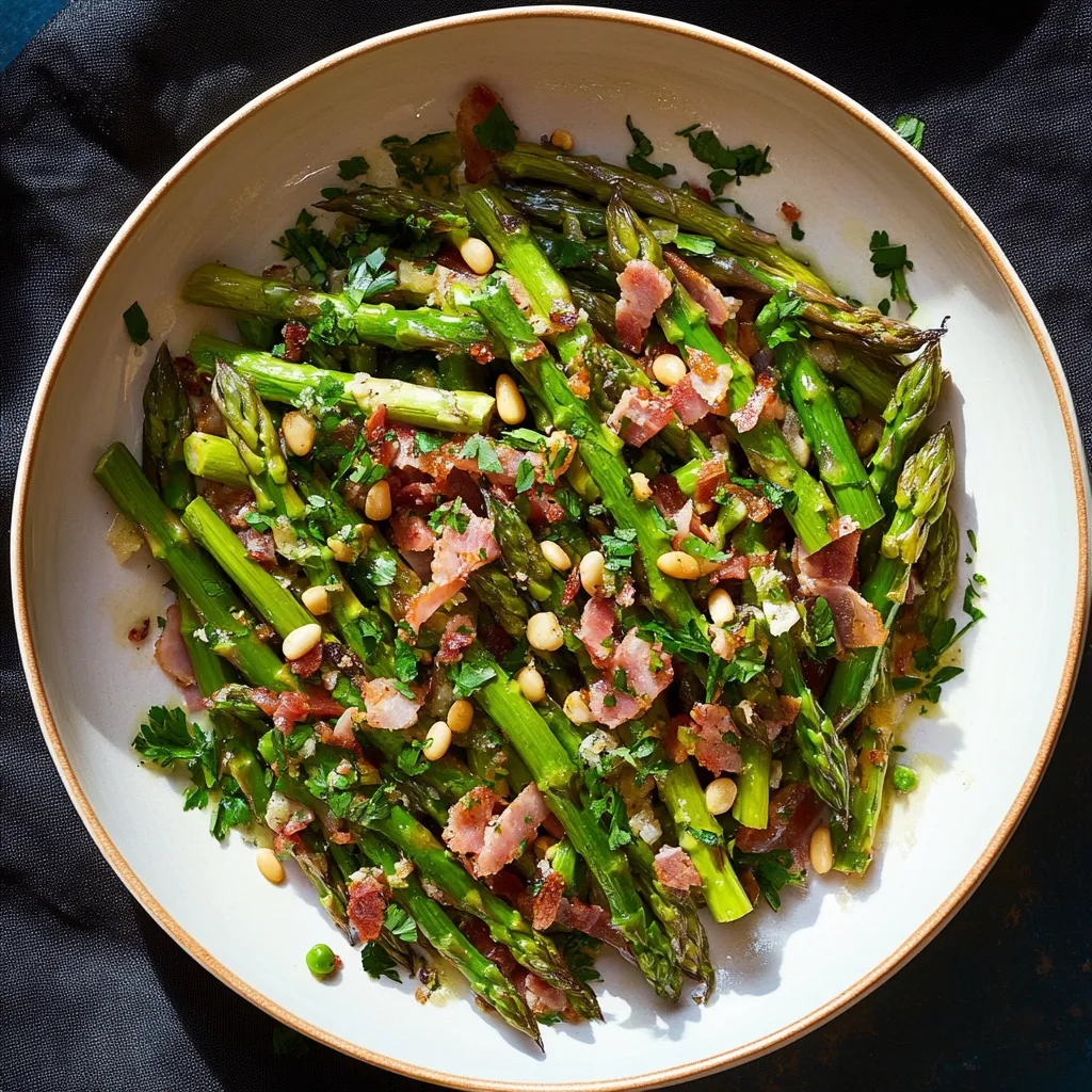 A bowl of asparagus with bacon and pine nuts.