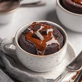A cup of chocolate cake with chocolate drizzle.
