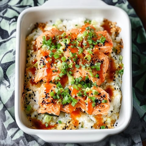 A white bowl with fish and vegetables.